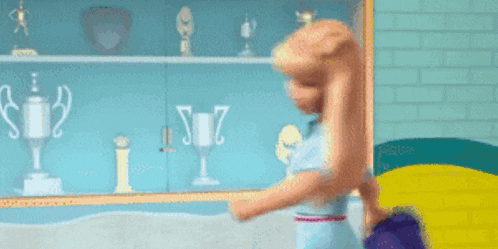 a barbie doll is holding a pot of flowers in front of a trophy case .