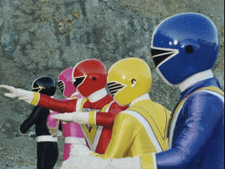 a group of power rangers are standing in a row with their arms outstretched