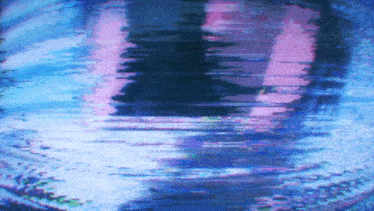 a blurry picture of a person 's face with a purple and blue background