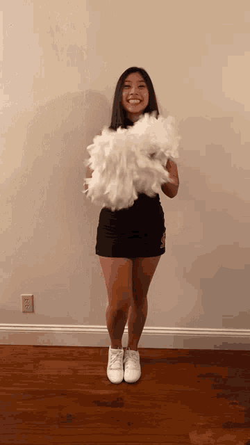 a cheerleader wearing a black skirt and white sneakers