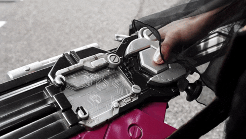 a close up of a person 's hand holding a device that says ' a ' on the top