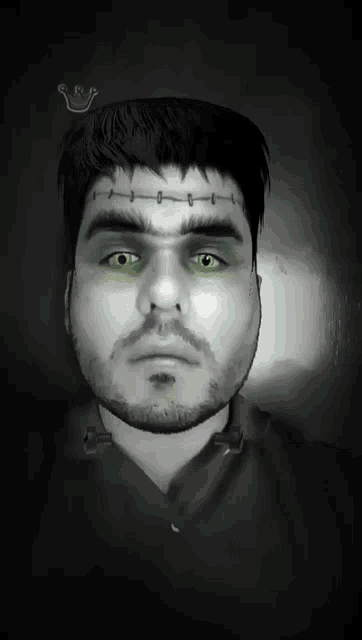a man with green eyes and stitches on his forehead looks like frankenstein