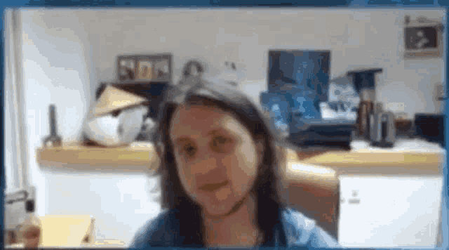 a woman with long hair is sitting in a chair in front of a computer monitor .