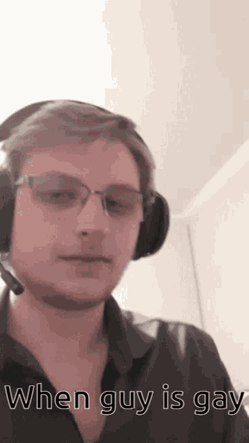 a man wearing headphones and glasses has the words when guy is gay below him