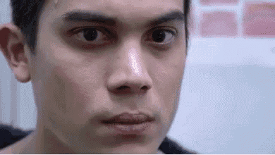 a close up of a man 's face with his eyes closed .