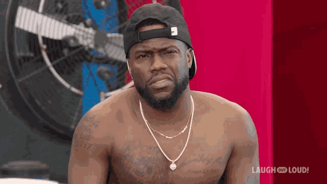 a shirtless man wearing a hat and a necklace with the words laugh and loud on the bottom right