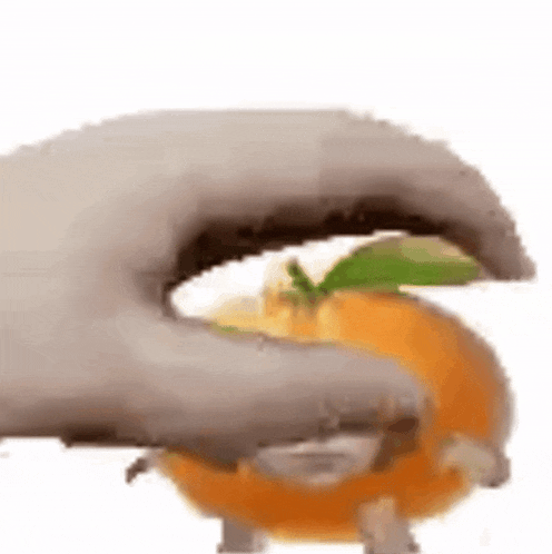 a close up of a hand holding an orange with a leaf on it .