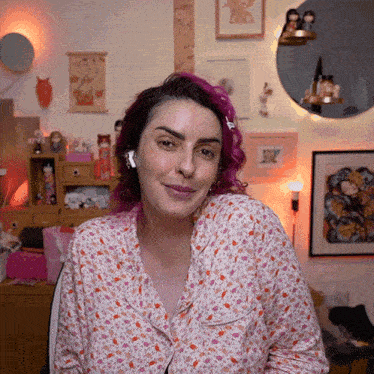 a woman with pink hair wearing a pajama top