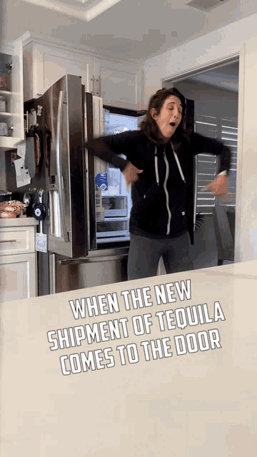 a woman is standing in front of a refrigerator with the words " when the new shipment of tequila comes to the door "