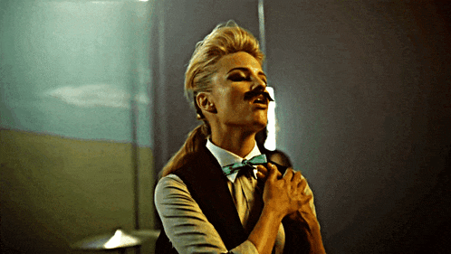 a woman wearing a fake mustache and bow tie