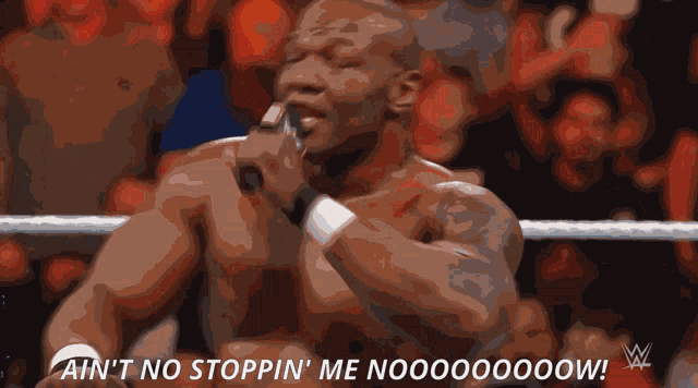 a man is singing into a microphone with the words " ain 't no stoppin ' me noooooow " below him