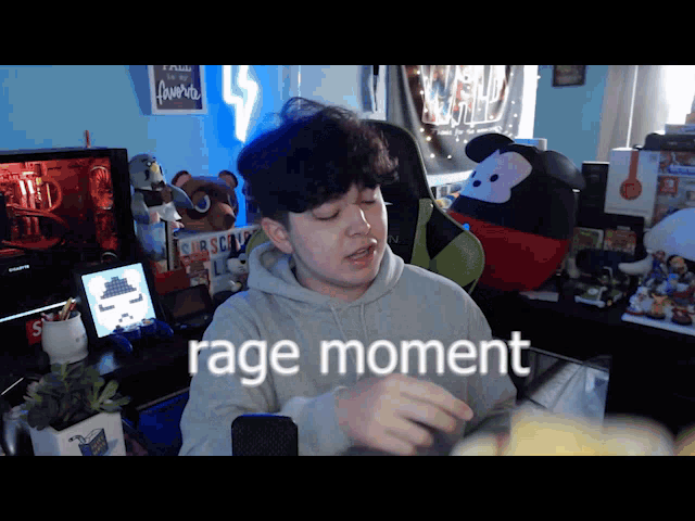 a man sitting in front of a microphone with rage moment written on the bottom