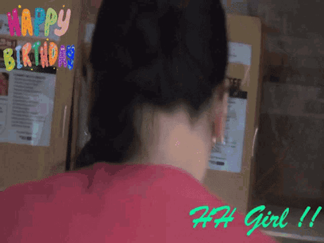 a woman 's back is shown in front of a sign that reads happy birthday