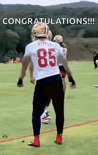a football player wearing a white jersey with the number 85 on it .
