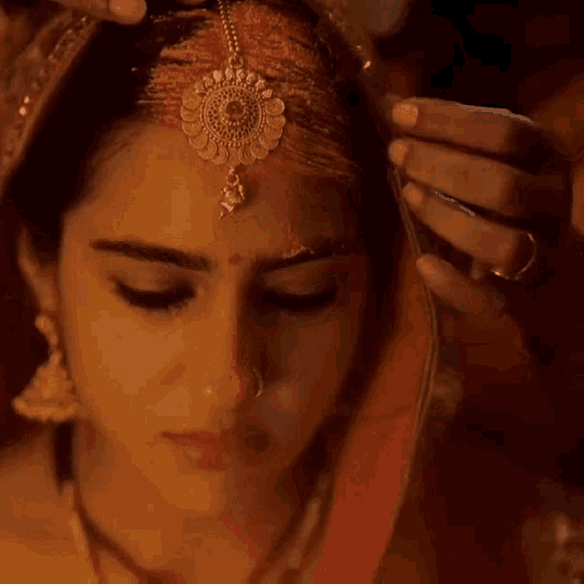 a close up of a woman 's face with tears coming out of her eyes .