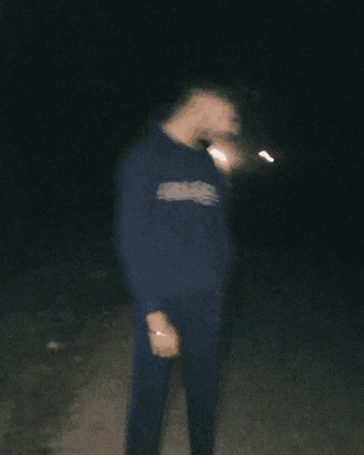 a blurry picture of a man wearing a blue sweatshirt