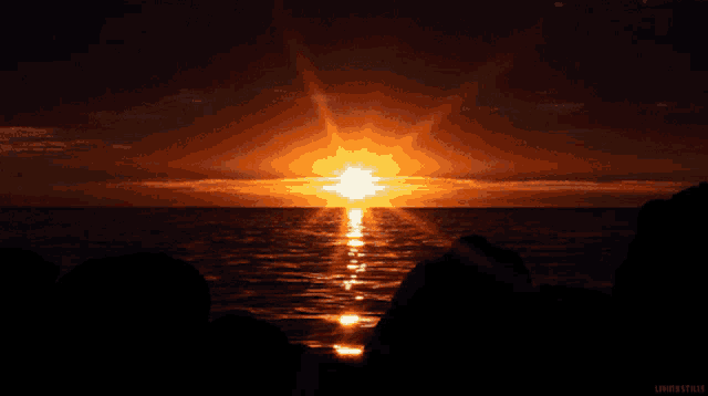 a sunset over a body of water with a watermark that says livingstills