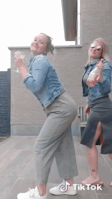 two women are standing next to each other with a tiktok logo on the bottom