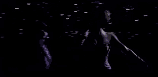 a woman in a purple dress is dancing in a dark room .