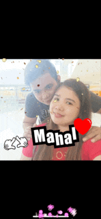 a man and a woman are posing for a picture and the woman has the name mahal on her chest