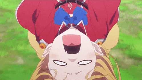 a girl in a red shirt with a blue bow is upside down .