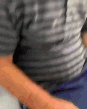 a close up of a person 's arm with a gray shirt on
