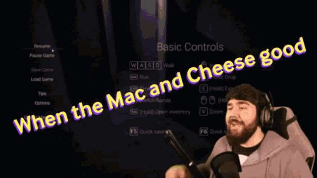 a man with headphones is sitting in front of a sign that says when the mac and cheese good
