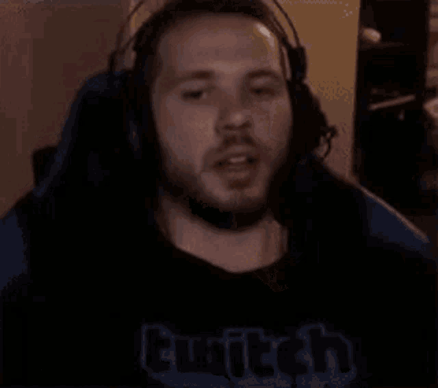 a man wearing headphones with the words shut the fuck up written below him