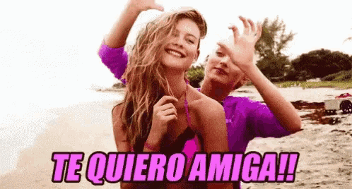 a man and a woman are standing on a beach with the words te quiero amiga written above them