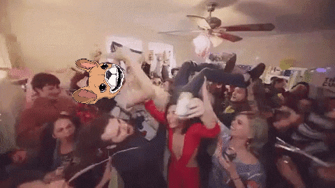 a group of people are gathered in a room with a sign that says the cup on it