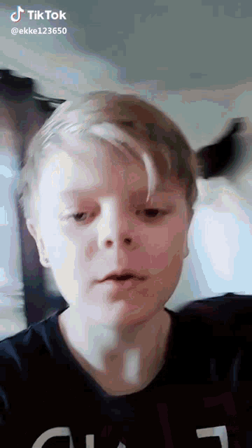 a close up of a boy 's face with a tiktok watermark