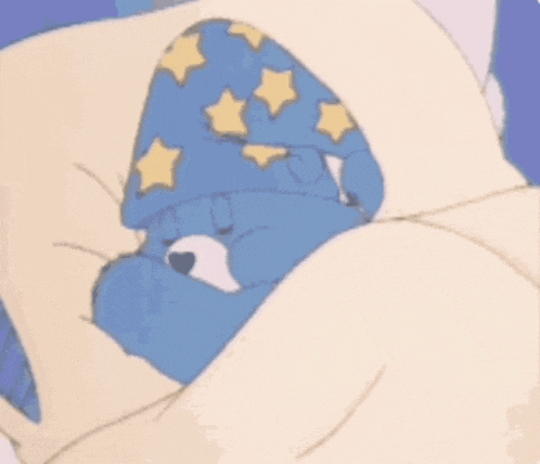 a care bear is sleeping in a bed with the words sweet dreams above him