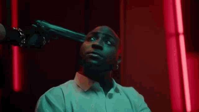 a woman is pointing a gun at a green van .