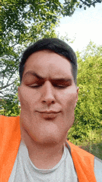 a man wearing a white shirt and an orange vest makes a funny face