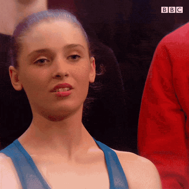 a close up of a woman 's face with the bbc logo visible