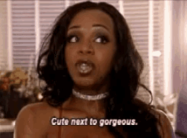 a woman is saying cute next to gorgeous in a room