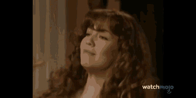 two women are dancing in a living room and the words watchmojo are on the bottom of the screen
