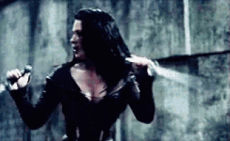 a woman is holding a sword and a microphone in her hand .