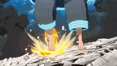 a person 's feet are on a rock with fire coming out of it