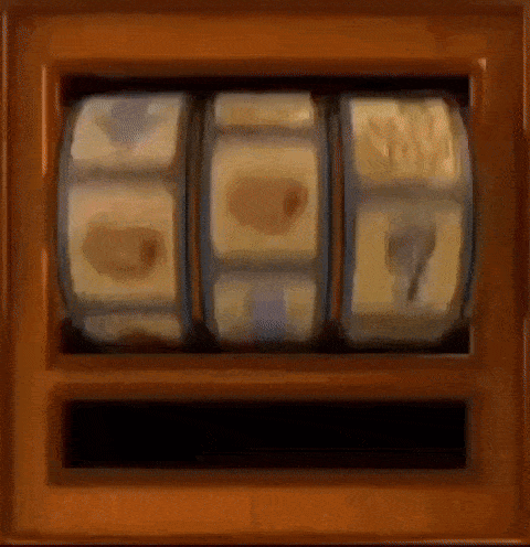 a slot machine is spinning in a wooden box with a few coins on it .