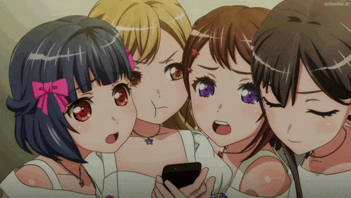 a group of anime girls are looking at a cell phone with animelist.tv in the corner