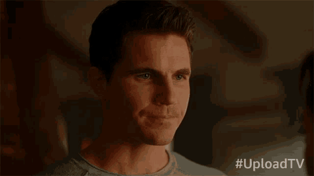 a close up of a man 's face with the hashtag uploadtv on the bottom