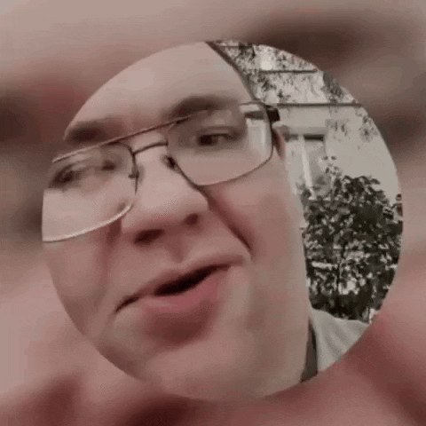 a man with glasses is looking through a circle
