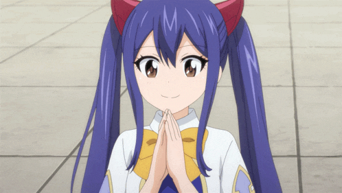 a girl with blue hair and red ears is smiling with her hands folded