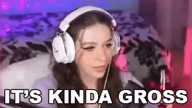 a woman wearing headphones is sitting in front of a computer with the words `` it 's kinda gross '' .