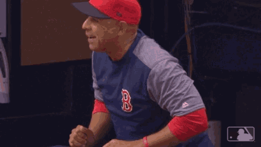 a man wearing a red sox shirt and hat