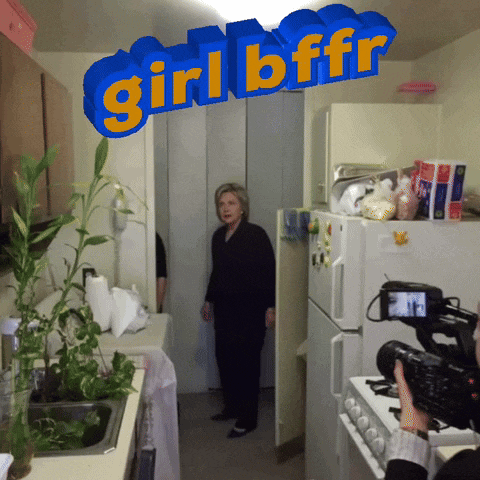 a woman stands in a kitchen with a sign that says girlbffr above her