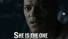 a close up of a person 's face with the words `` she is the one '' written on it .