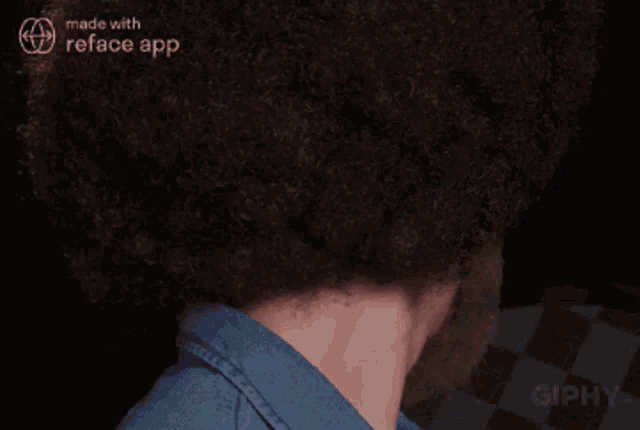 a man with an afro and beard is made with the reface app and is smiling