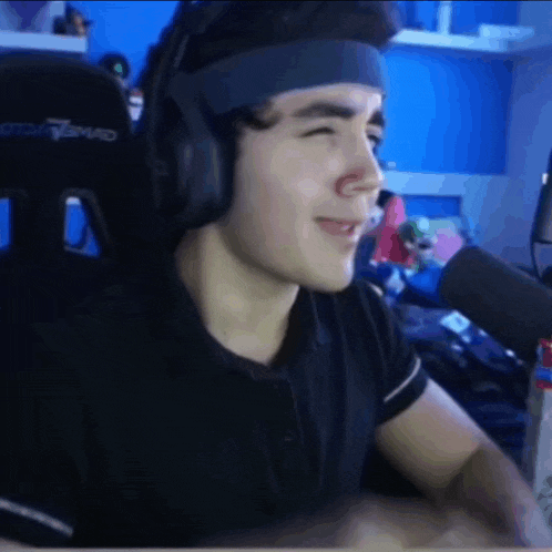 a young man wearing headphones and a headband with the word squad on it
